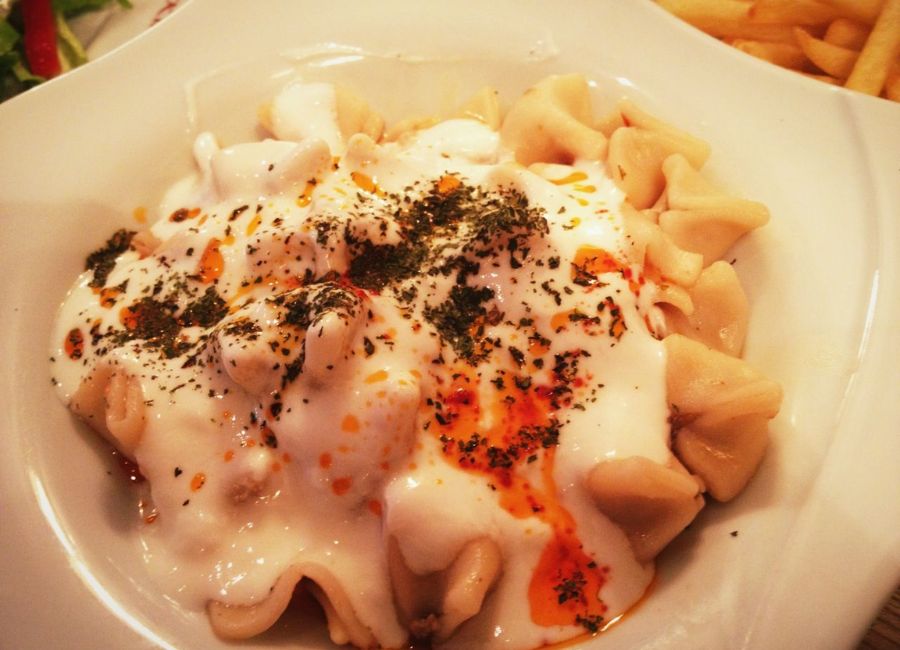 Turkish manti dumplings served with yogurt and crispy börek