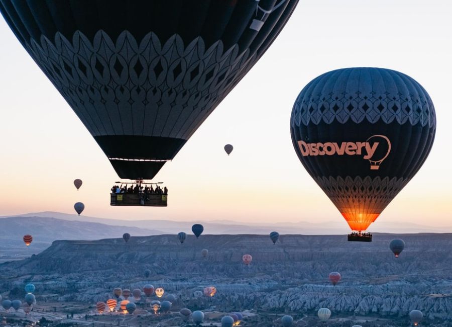 Hot air balloon ride over Cappadocia at sunrise with panoramic valley views