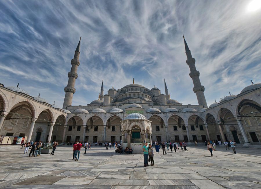 Visitors entering the Blue Mosque respectfully